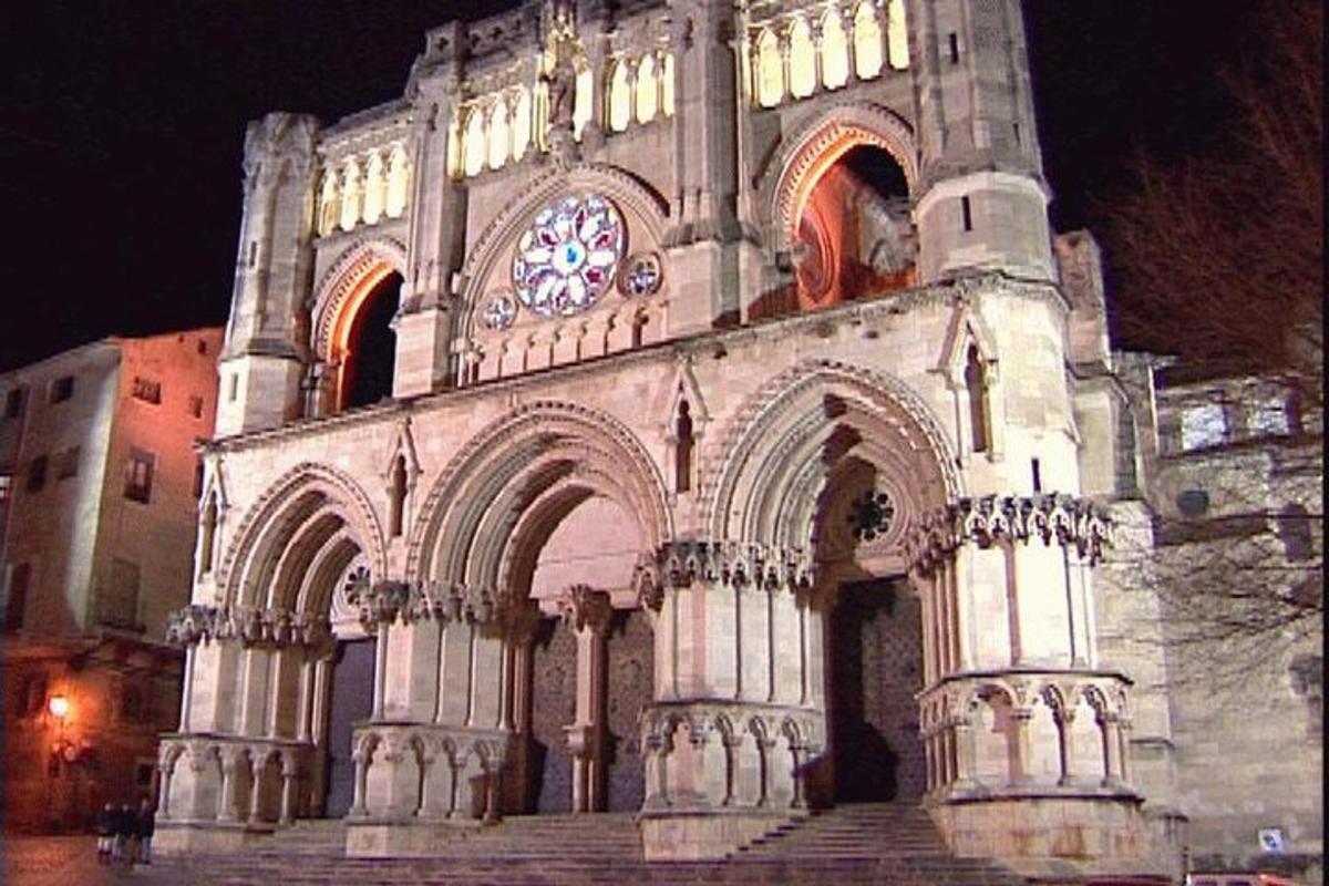 a large building with a clock tower at night