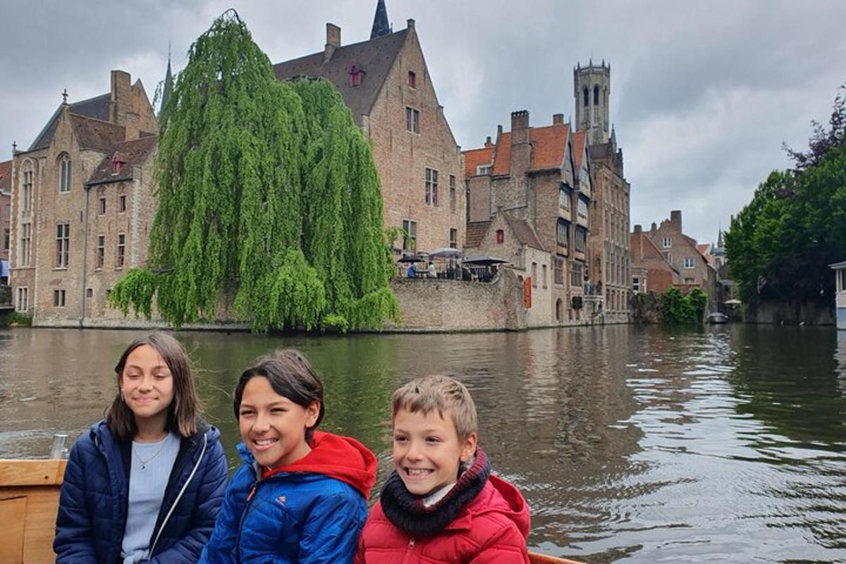 three children riding in a boat on a river