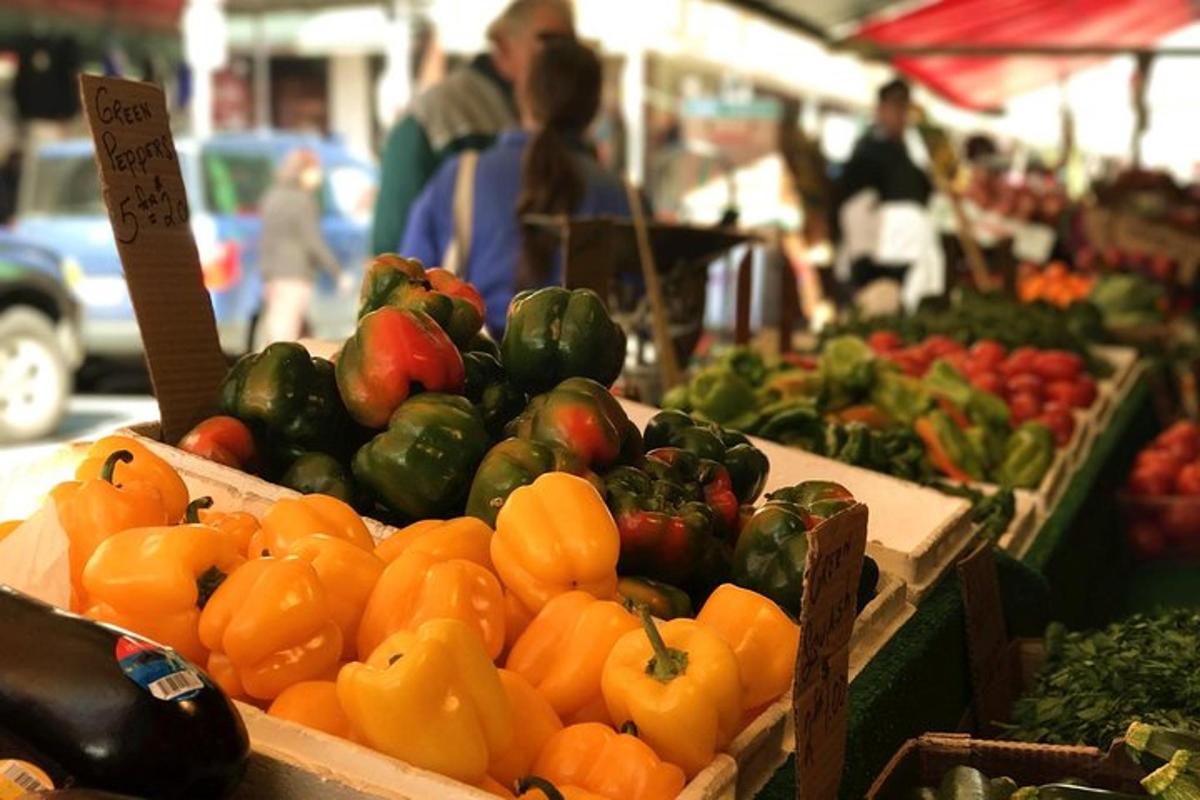 a display of tomatoes and peppers at a market