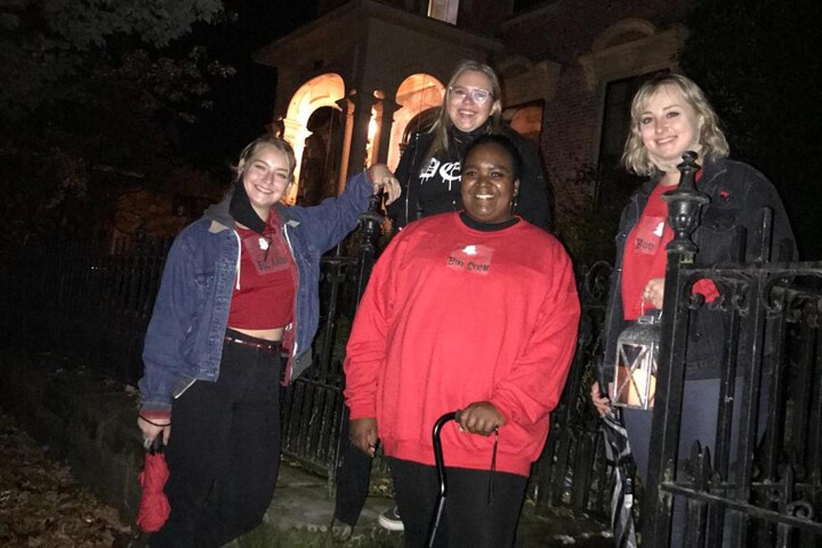 a group of people standing in front of a fence