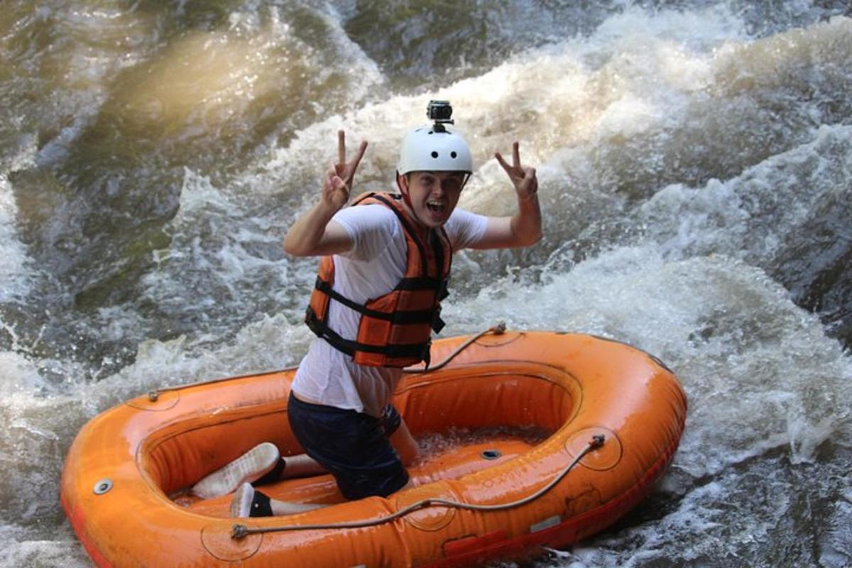 a man in an orange raft in the water