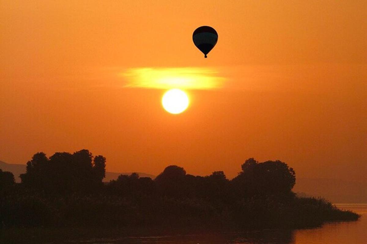 a hot air balloon flying in the sunset