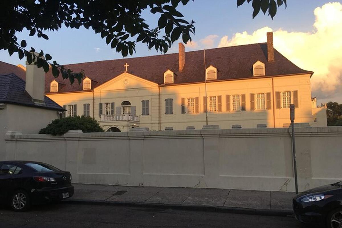 a large white house with a fence in front of it