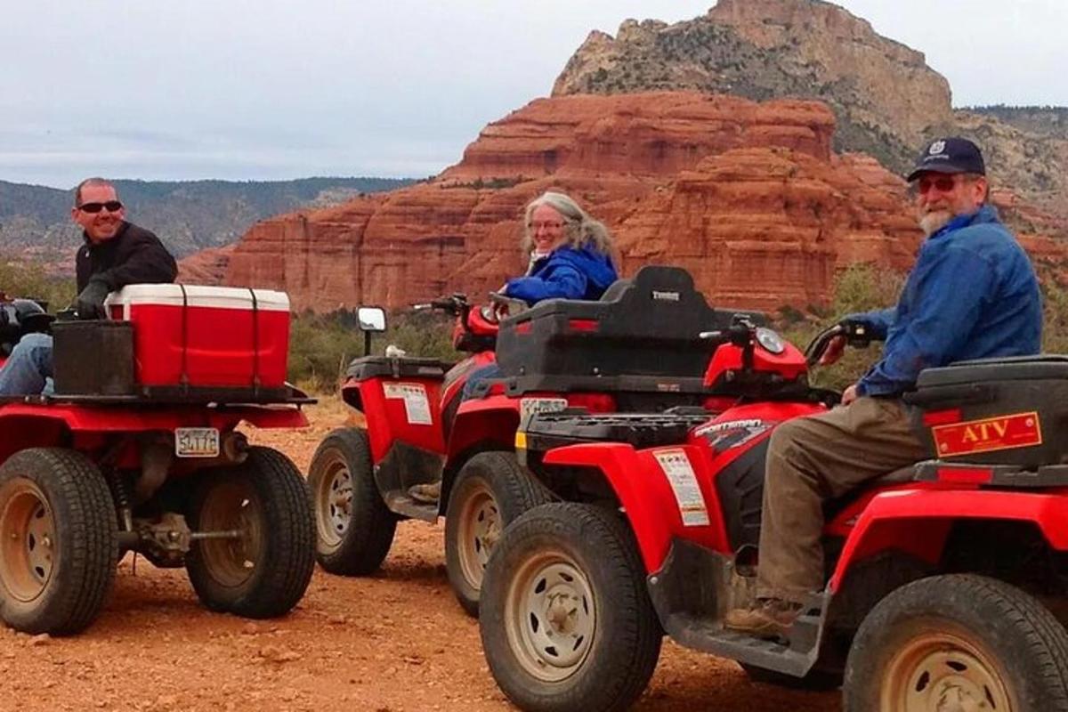 a group of people riding on atvs in the desert