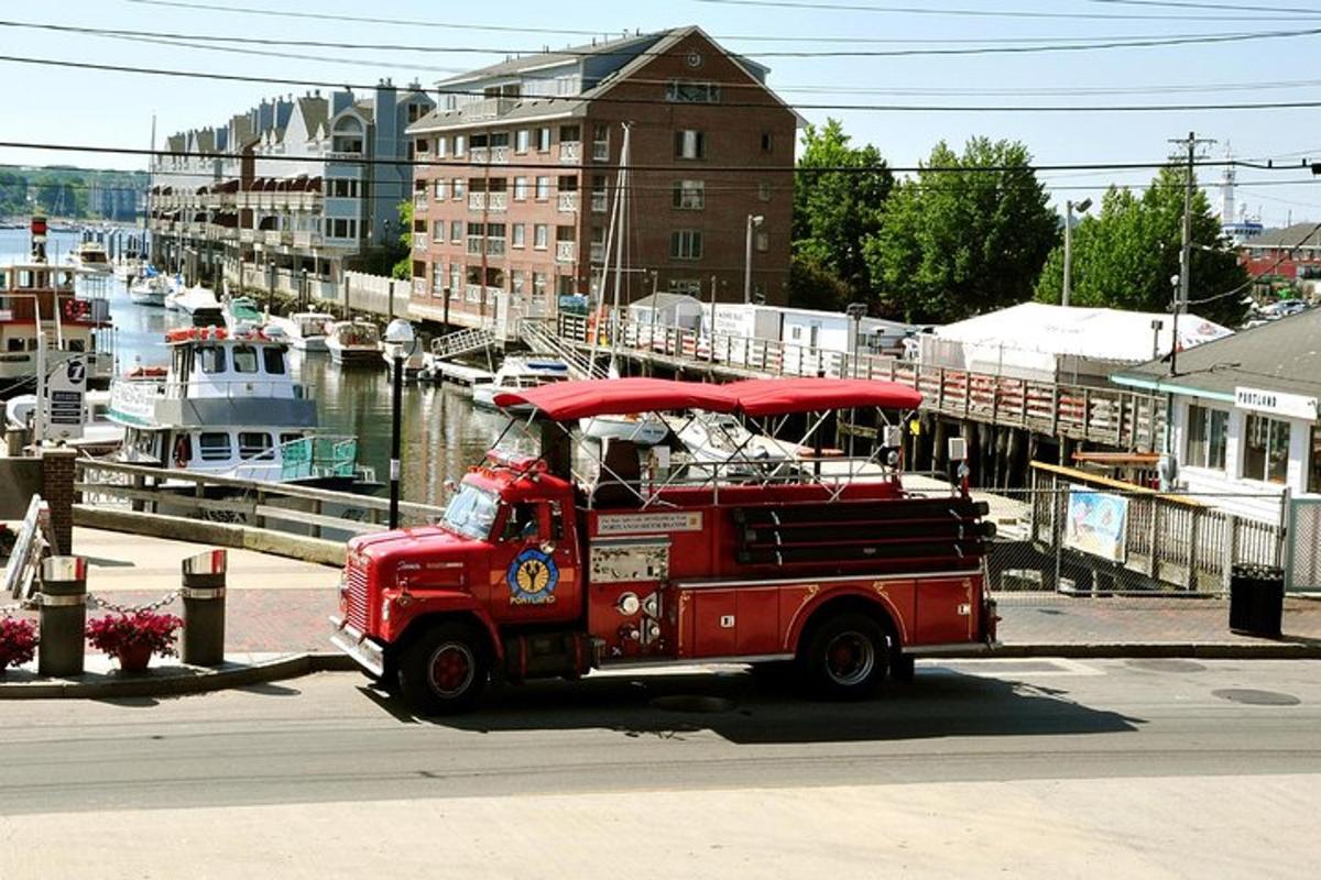 an old red fire truck driving down a street