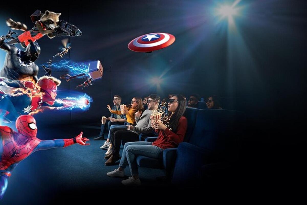 a group of people sitting in a theater watching a movie
