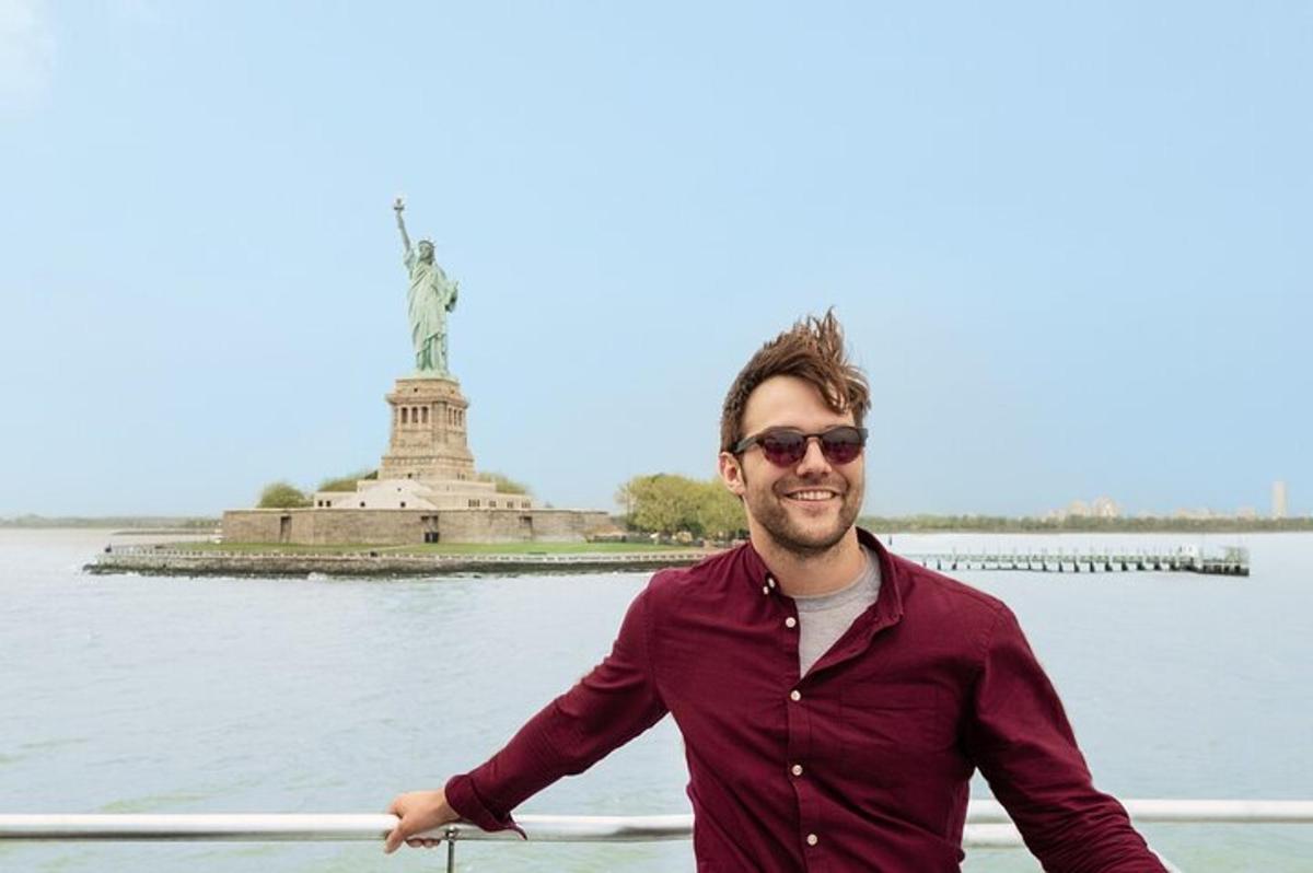 a man in a boat in front of the statue of liberty