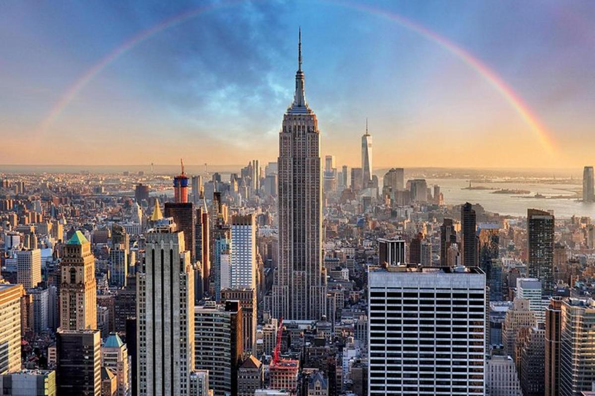 a view of a city with a rainbow in the sky