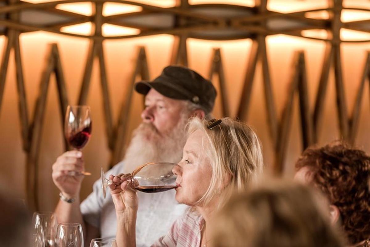 a group of people sitting at a table drinking wine