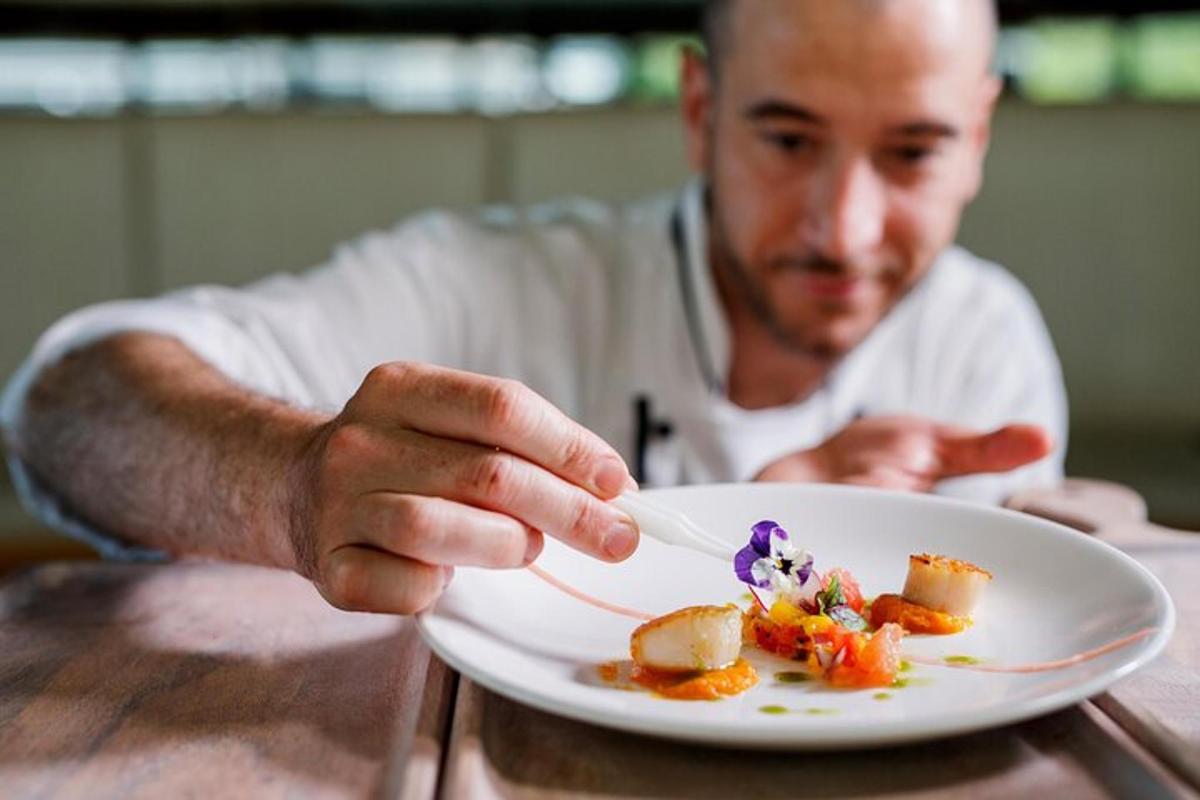 a man sitting at a table with a plate of food