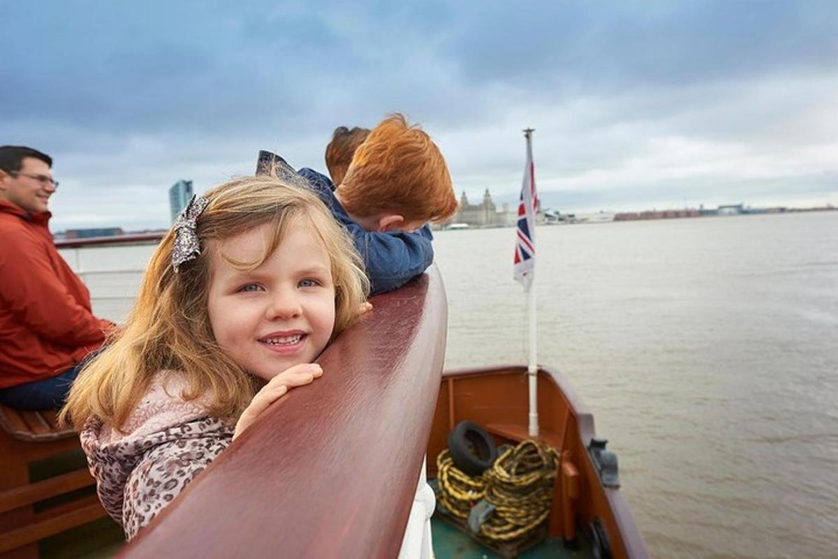 a little girl sitting on the back of a boat