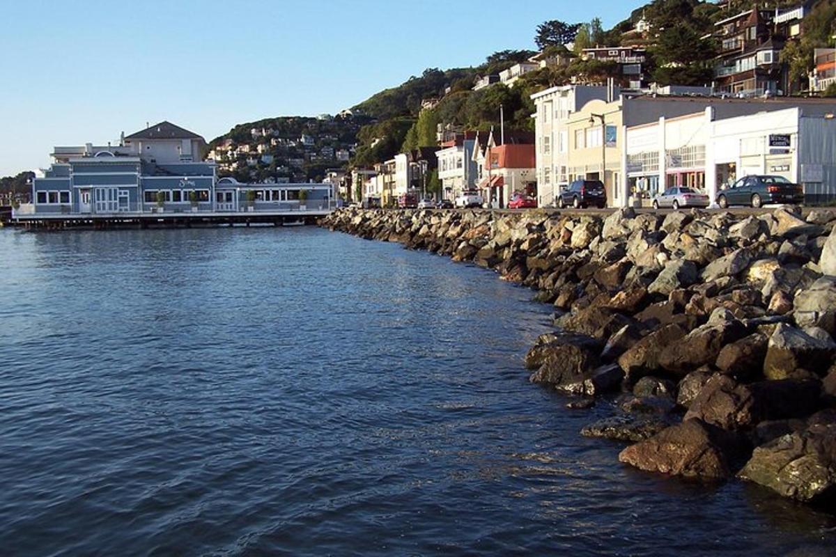 a body of water next to some rocks and buildings