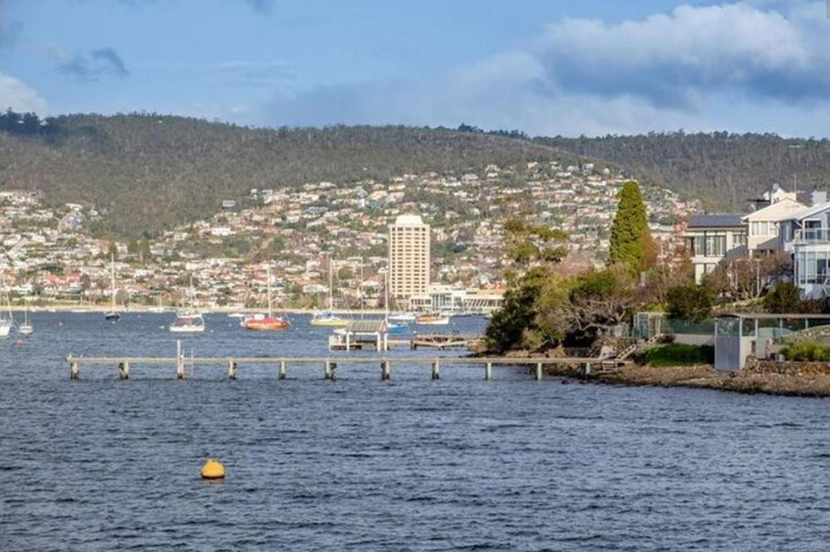 a large body of water with a city in the background