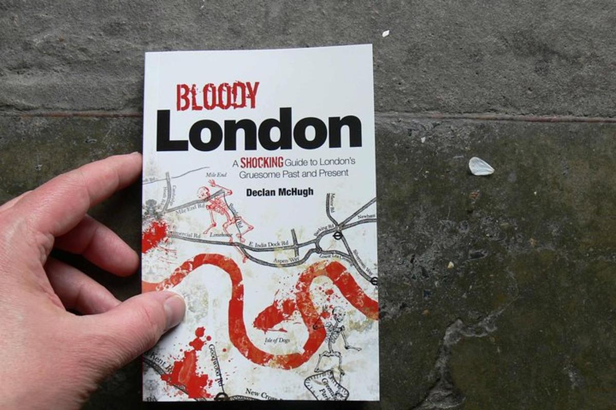 a person is holding a book about a library london