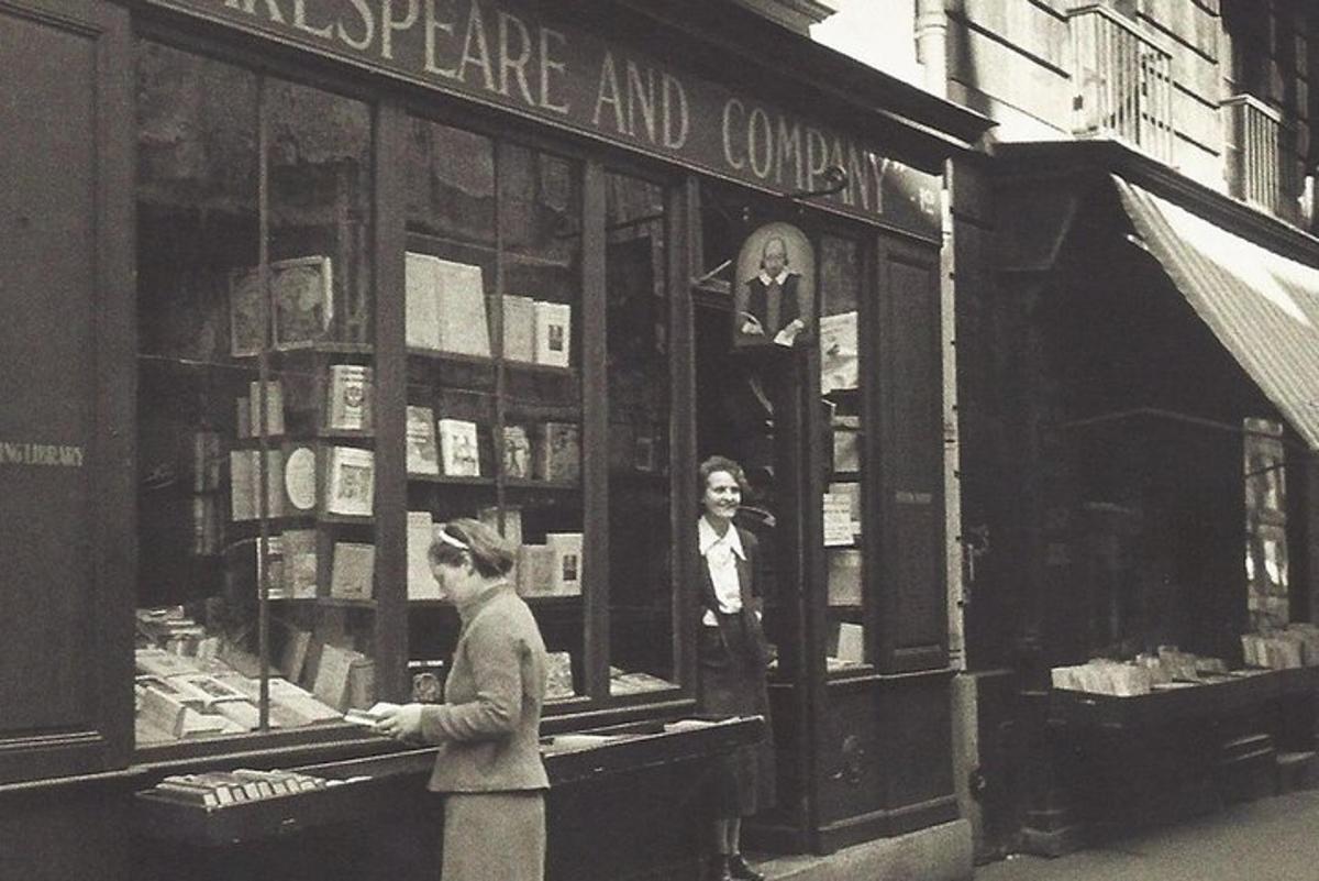 a couple of people standing outside of a book store