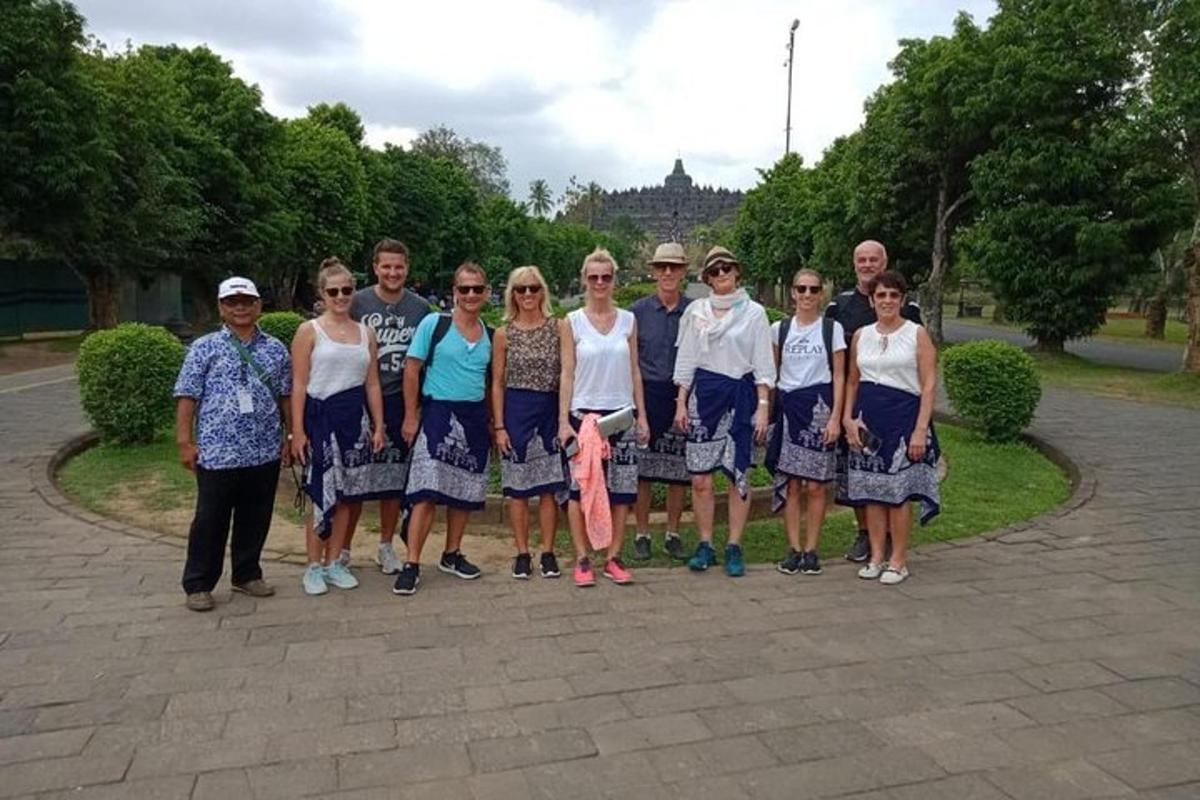a group of people posing for a picture in a park