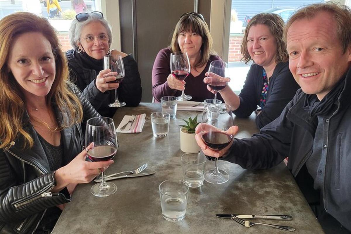 a group of people sitting around a table with wine glasses