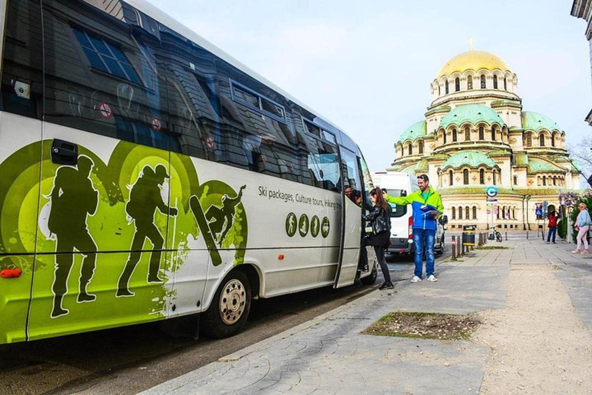 a group of people standing next to a bus