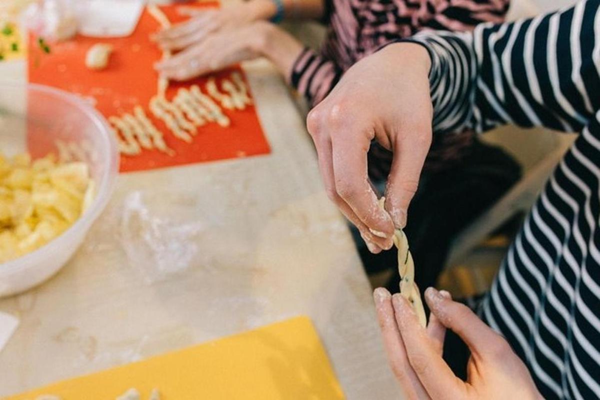 a person cutting up food on top of a counter