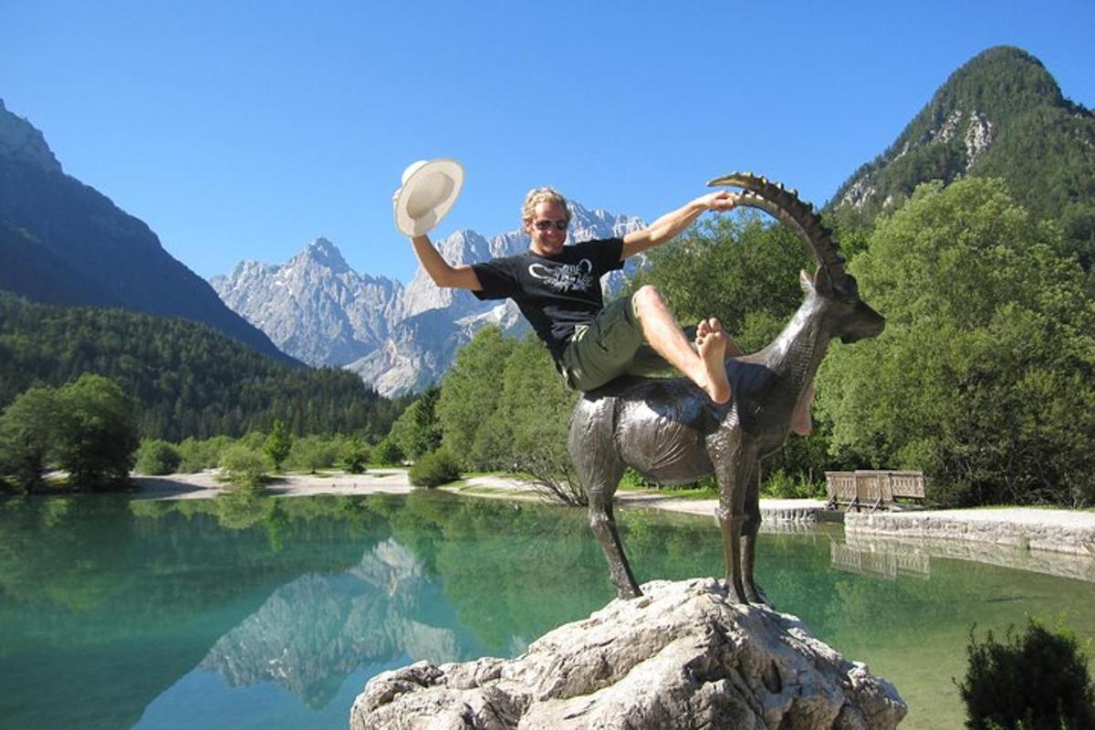 a statue of a man on a goat holding a frisbee