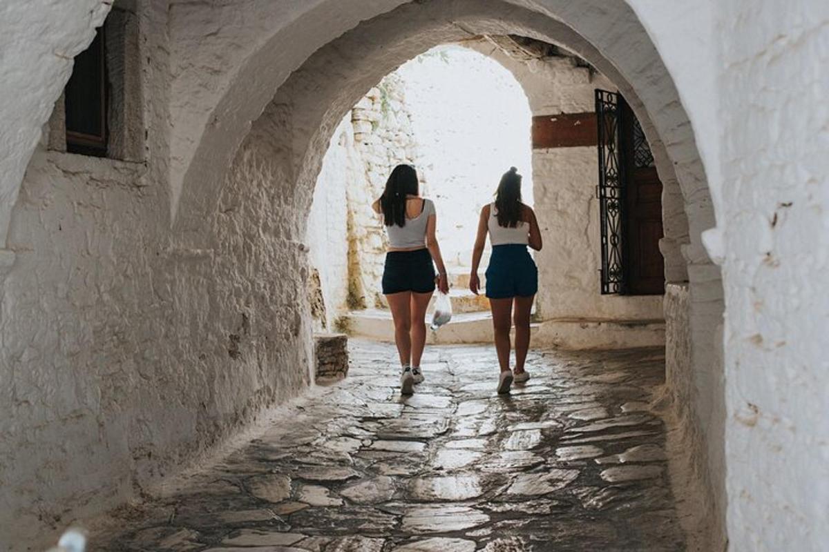 two women walking down an alley in an archway