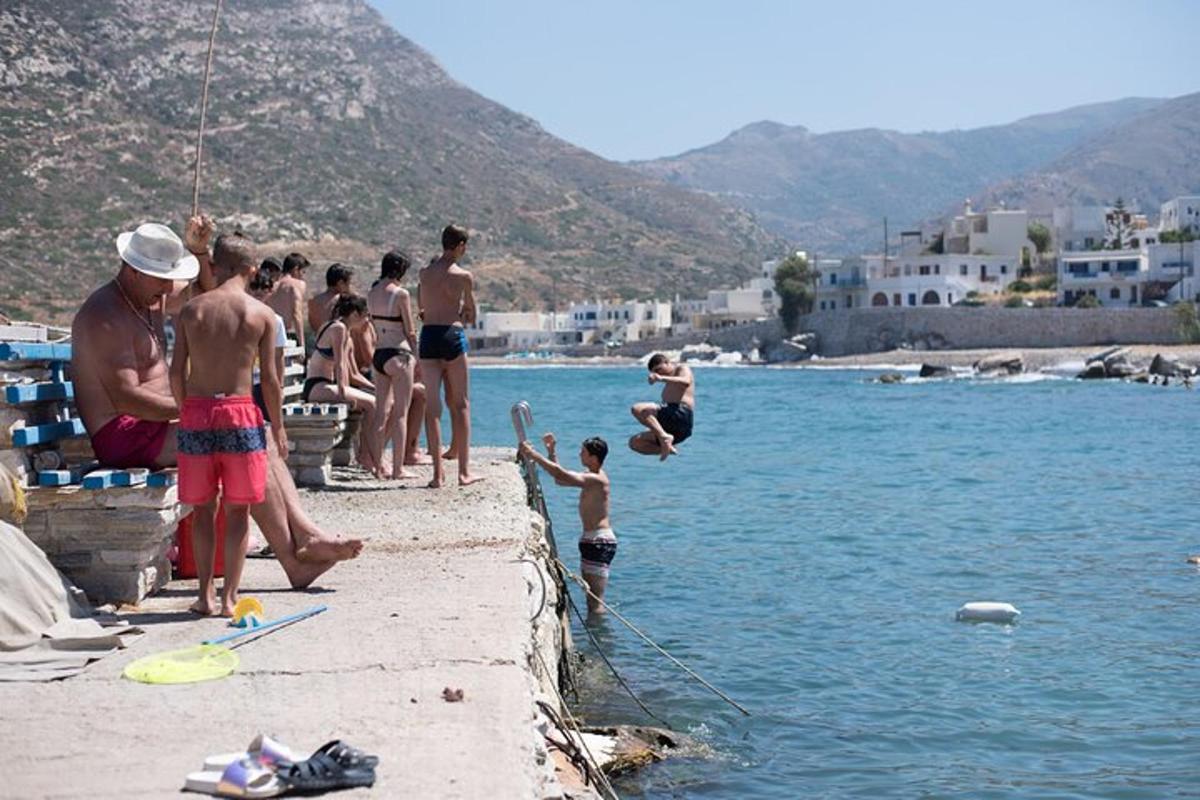 a group of people playing in the water at the beach