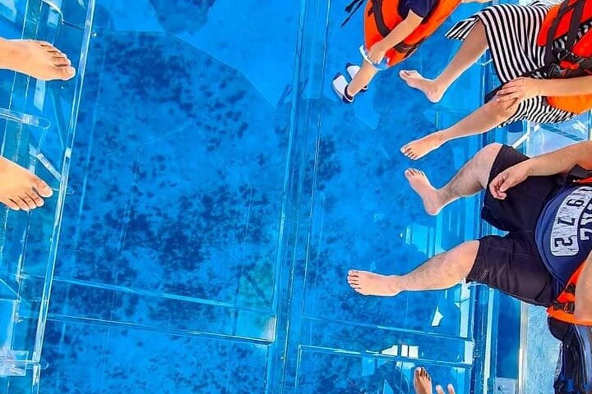 a group of people sitting on a glass wall