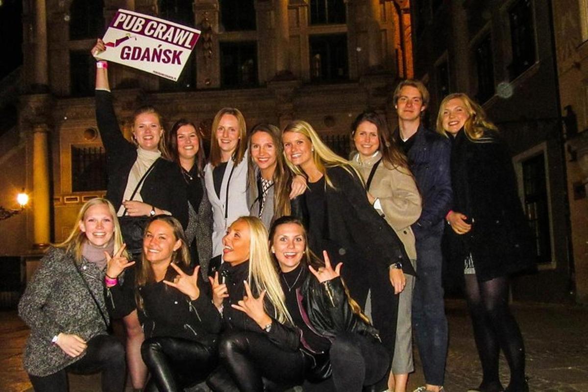 a group of people posing for a picture with a sign