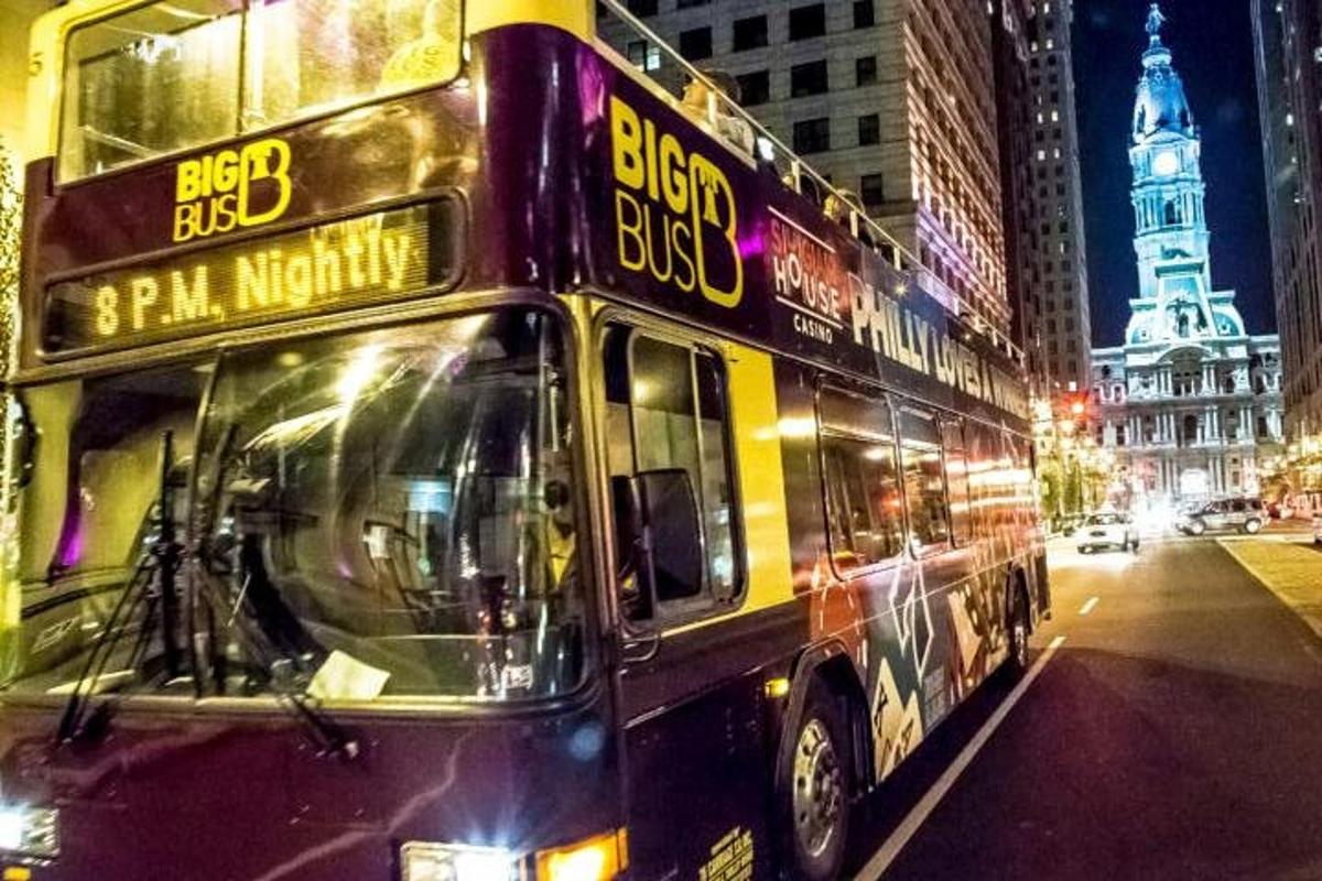 a double decker bus on a city street at night