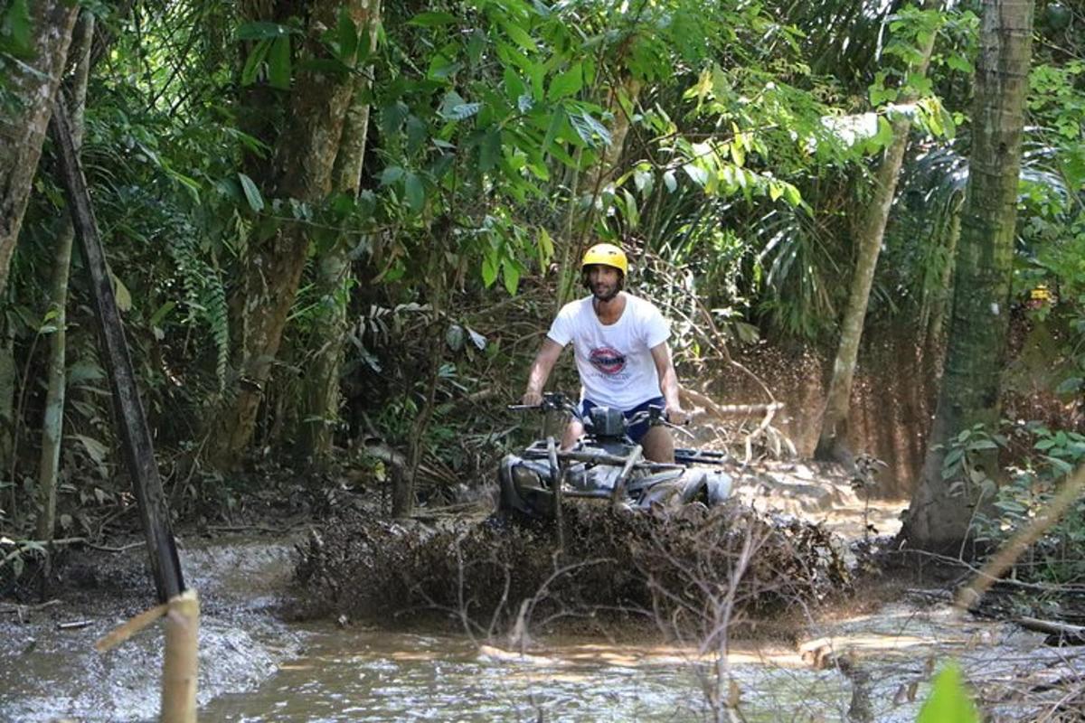 a man on an atv crossing a river