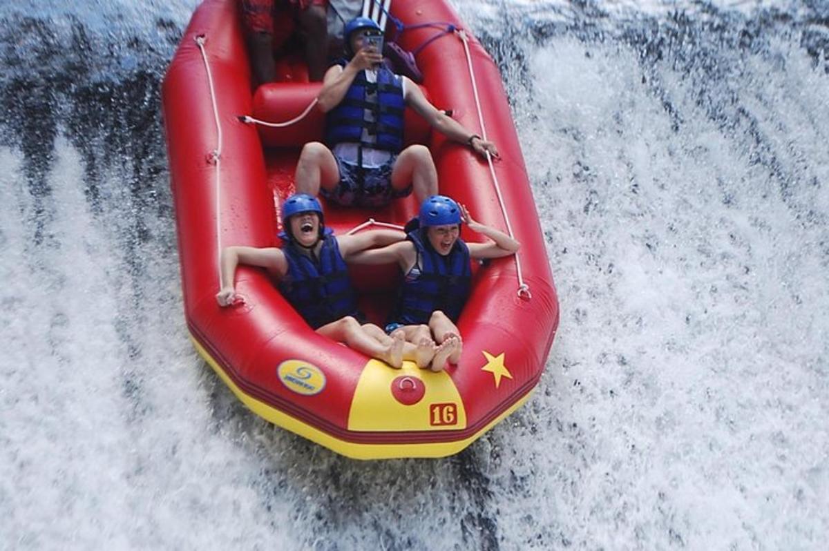 a group of people riding on a raft in the water