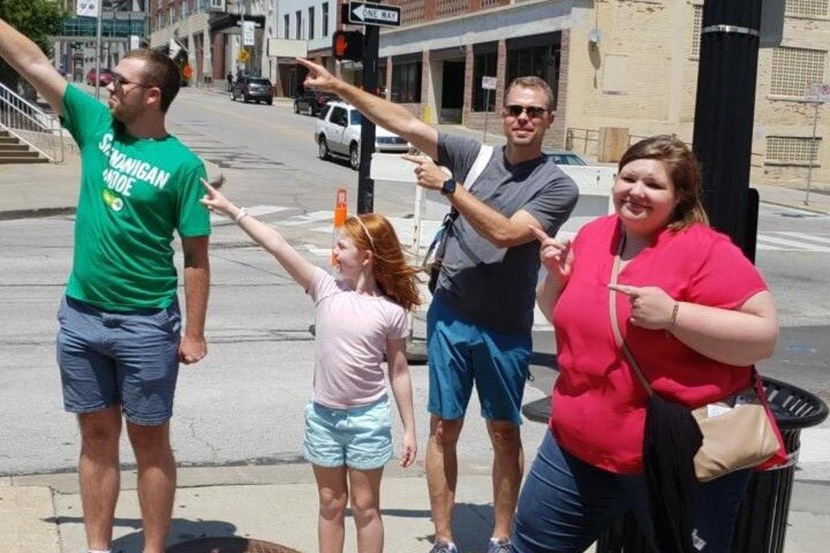 a group of people standing on a street corner