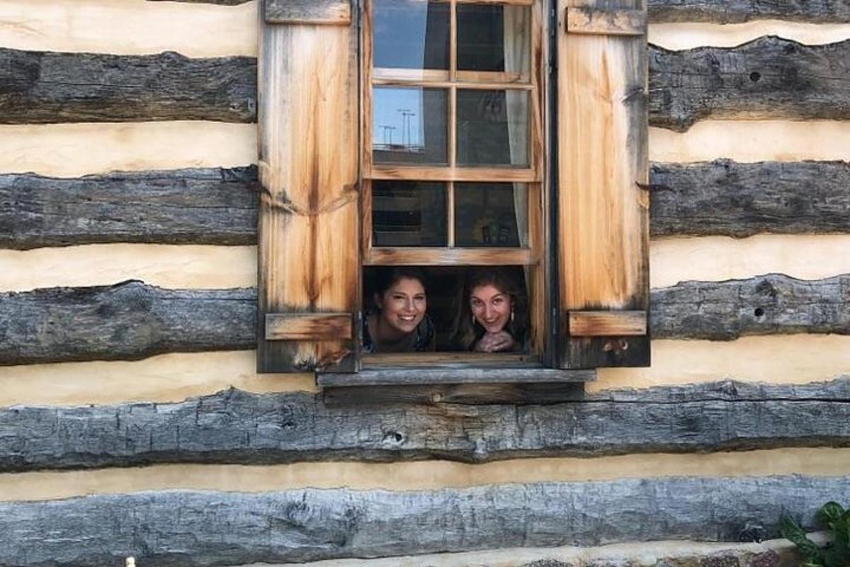 two people looking out of a window of a building