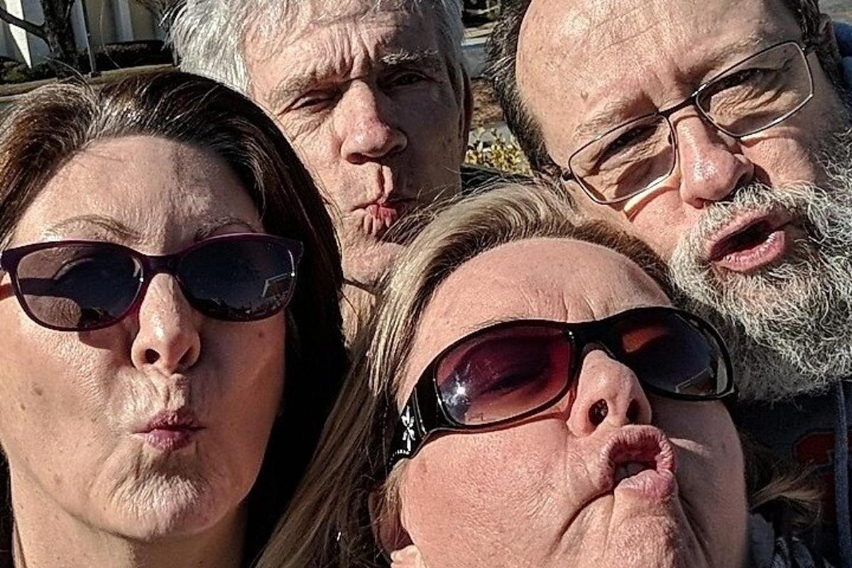 a group of four older people wearing sunglasses