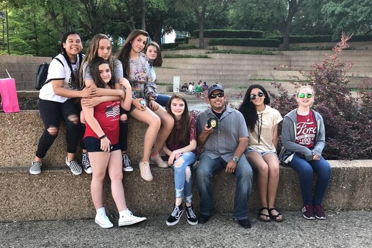 a group of people sitting on a stone wall