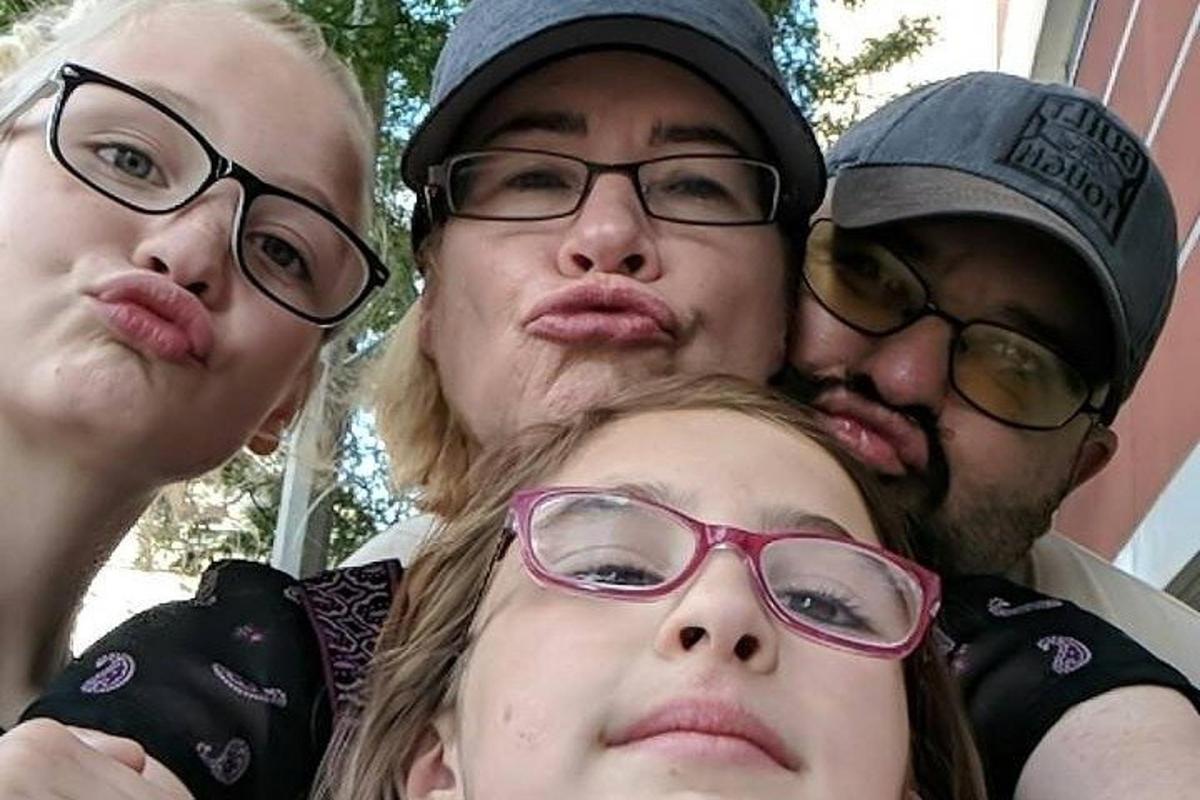 a group of four people posing for a picture