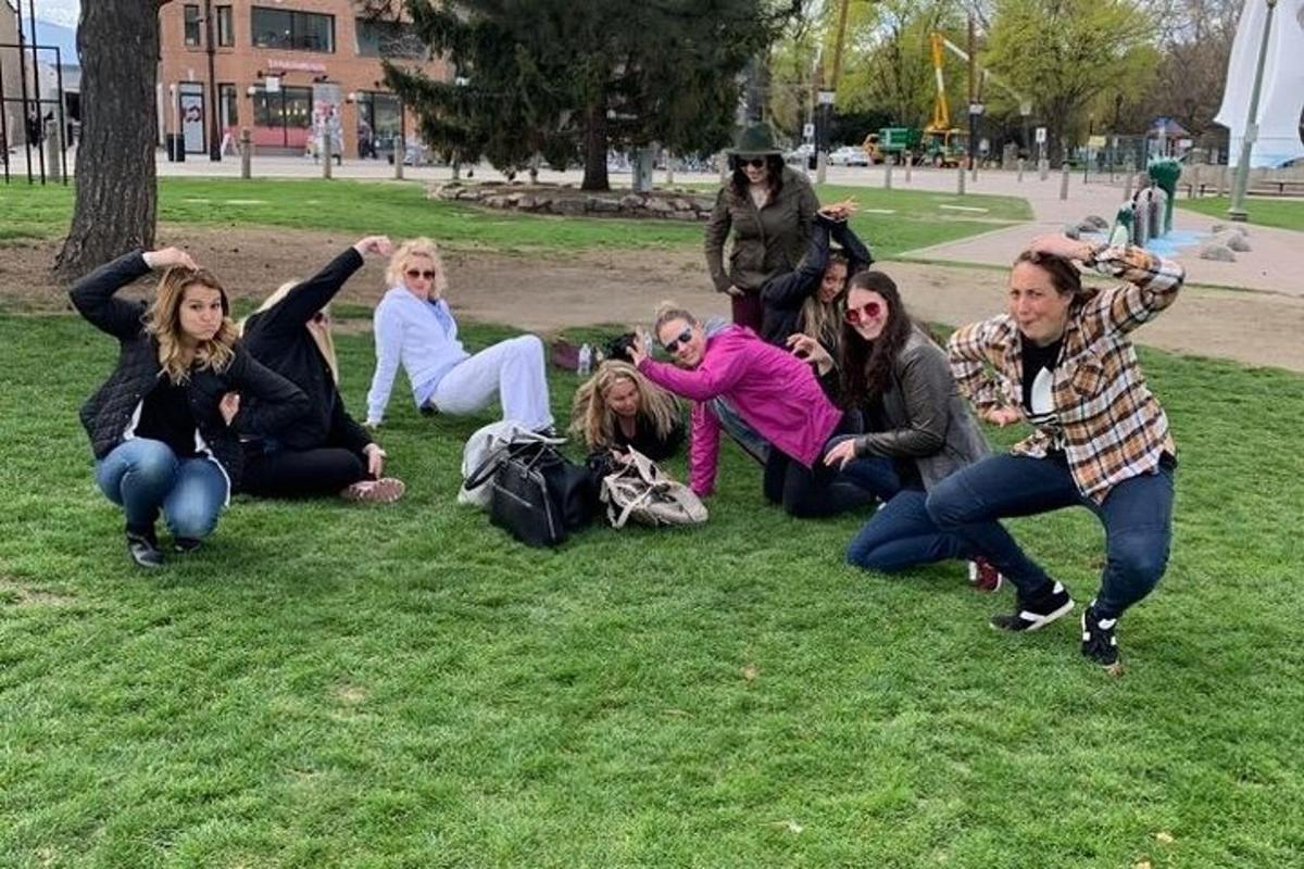 a group of people sitting on the grass in a park