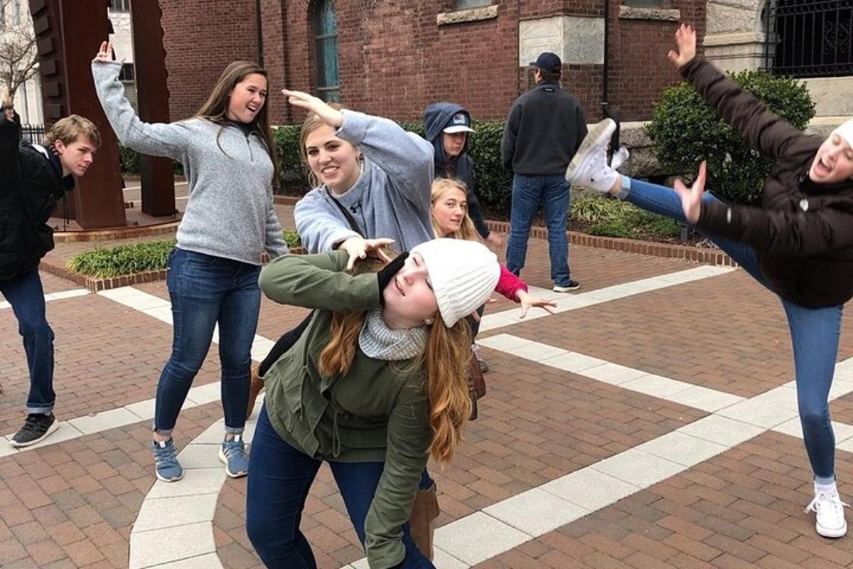 a group of people dancing in front of a building