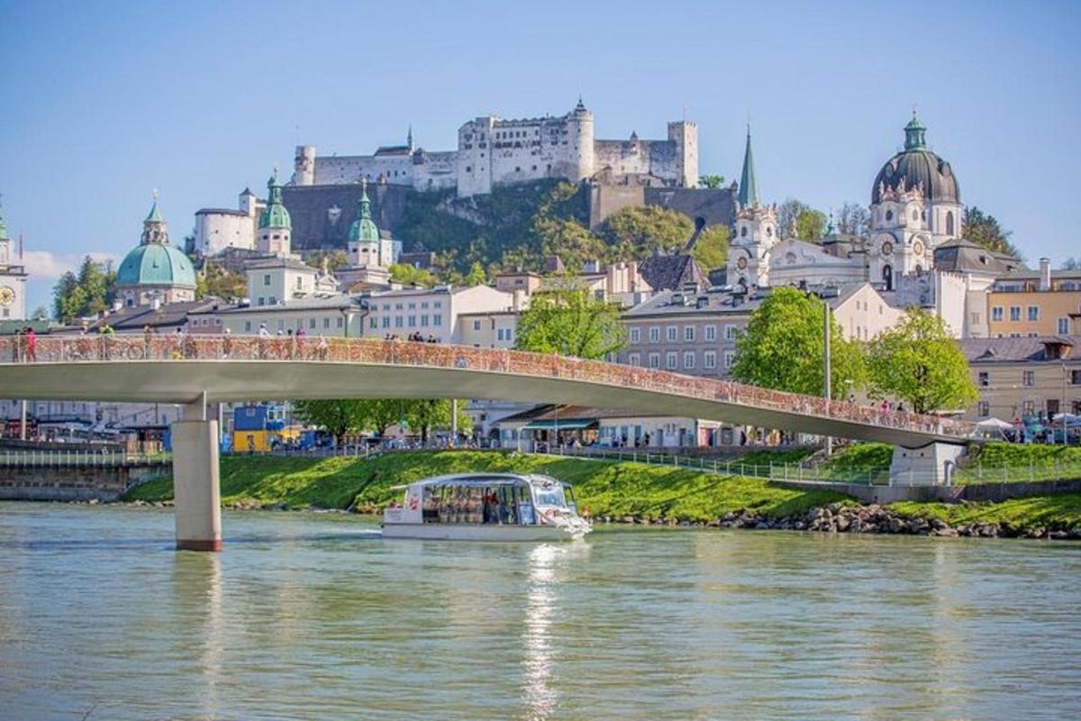 a bridge over a river with a city in the background