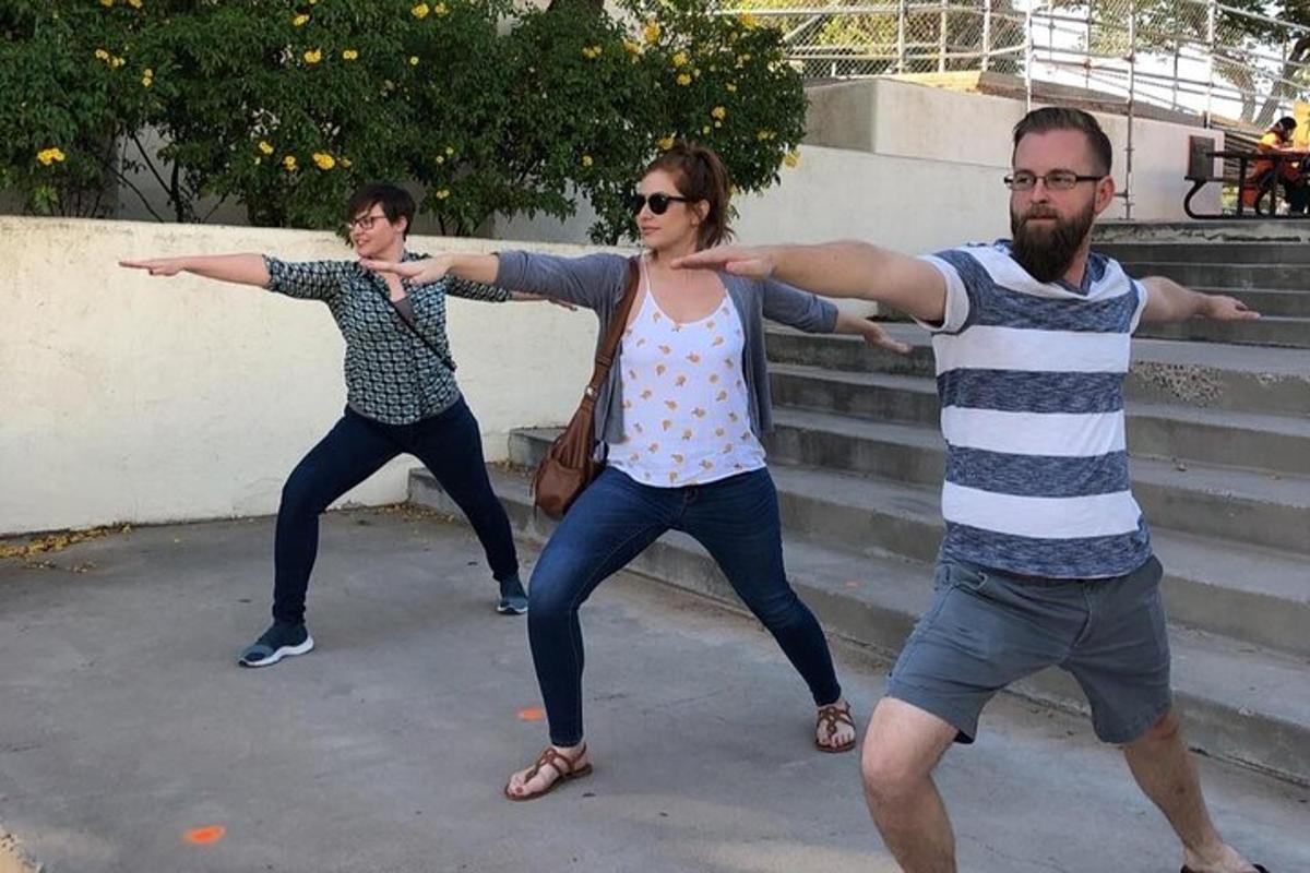 three people standing on some steps with their arms out