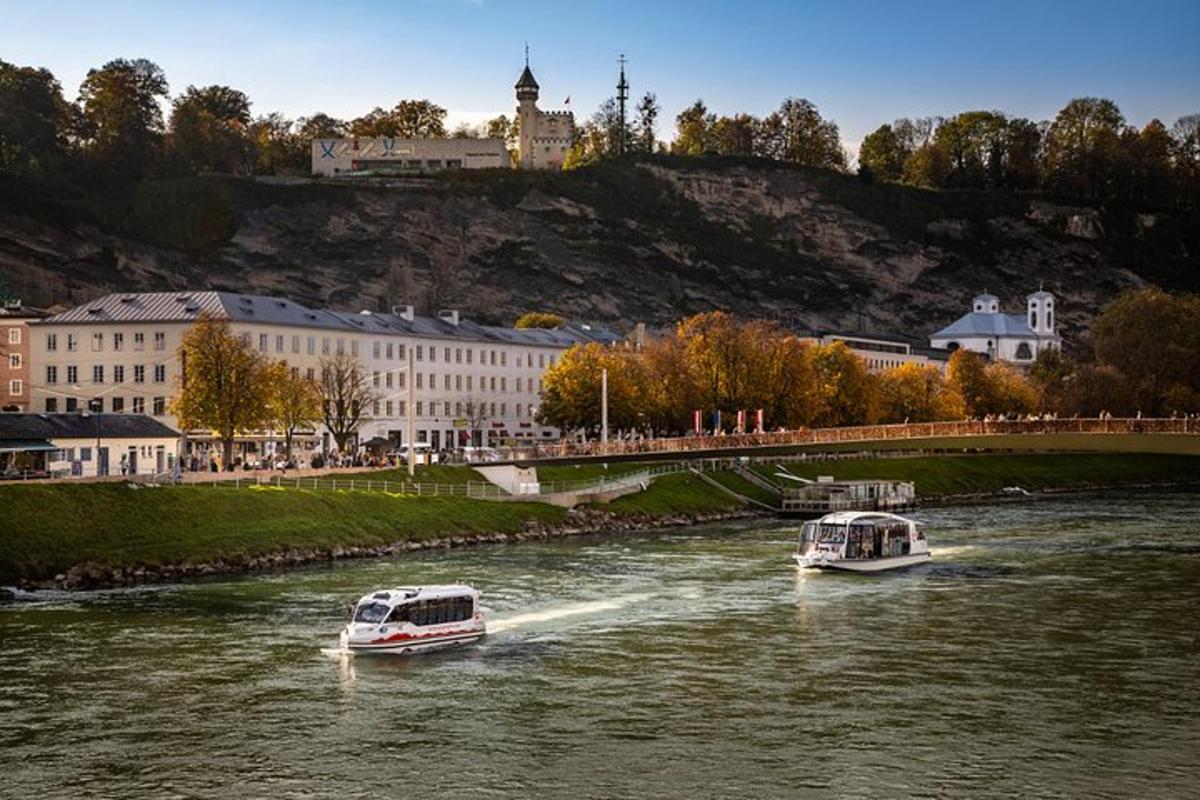 two boats traveling down a river in a city