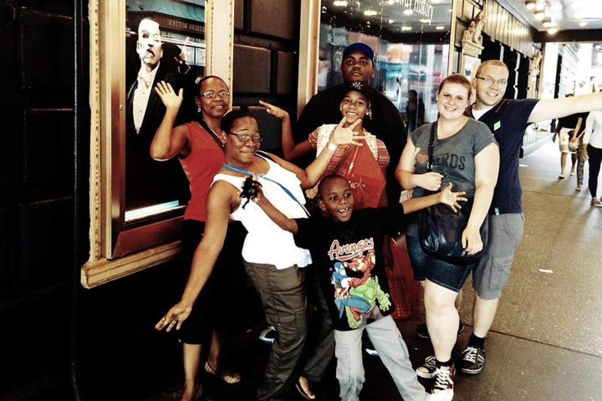 a group of people posing for a picture on a sidewalk