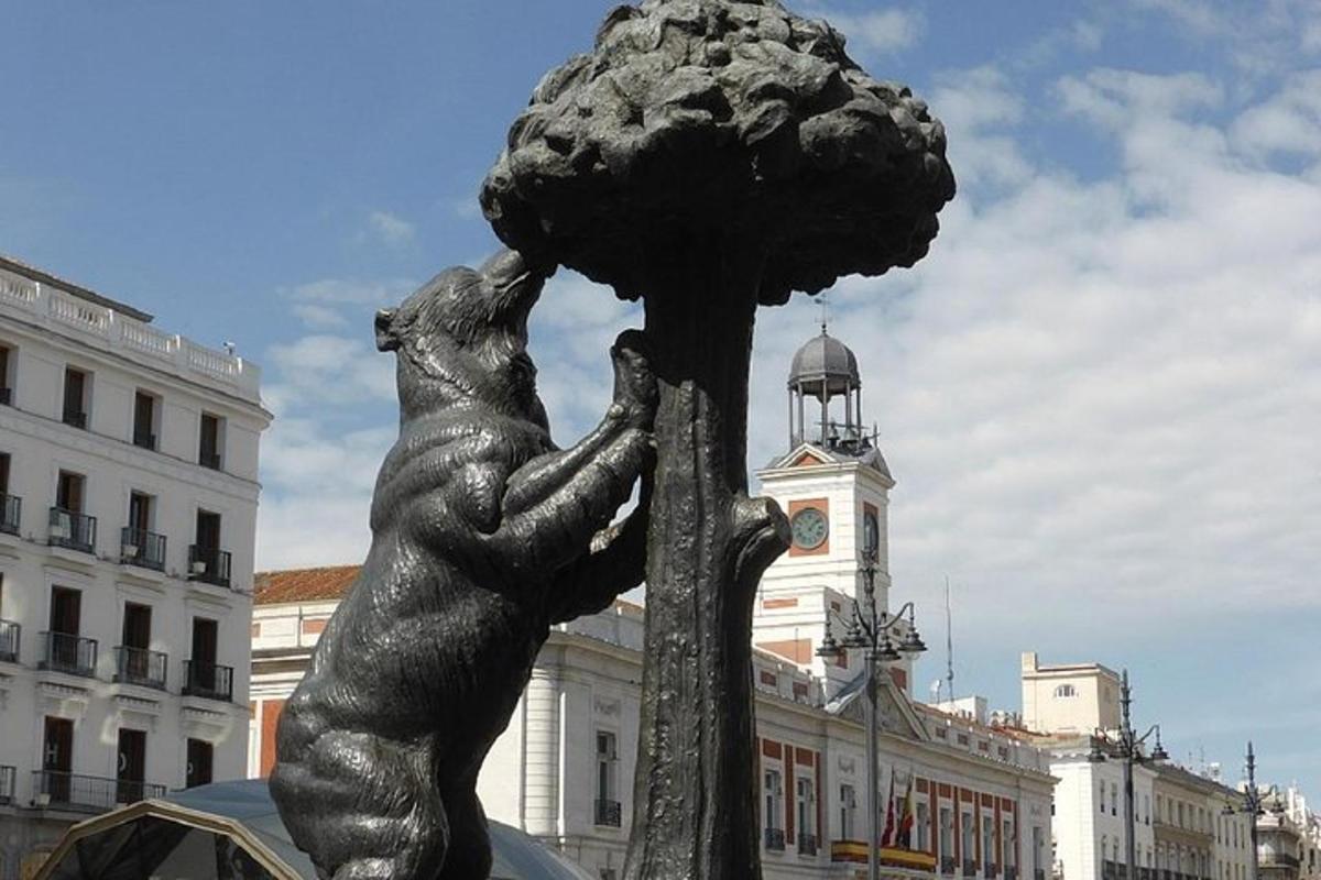 a statue of a bear playing with a tree