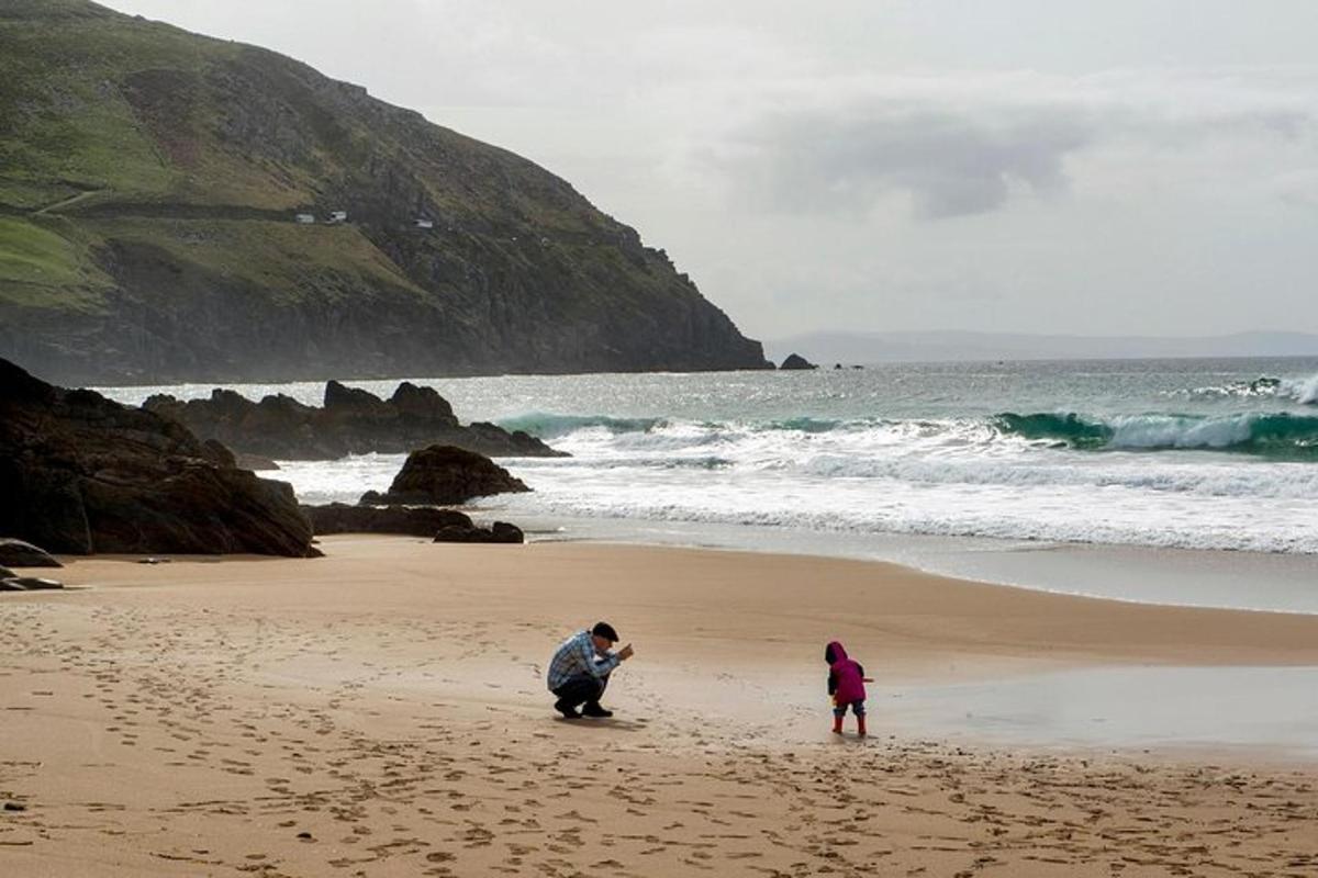 a man and a child playing on the beach
