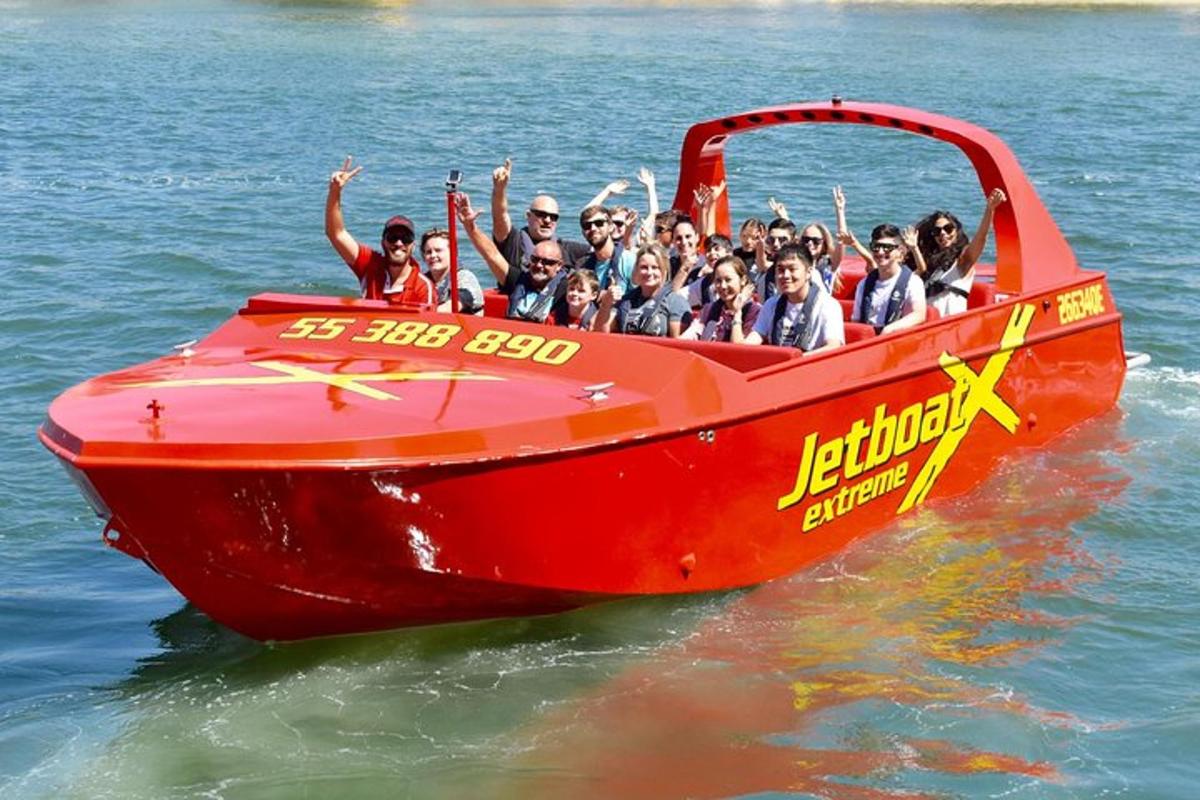 a group of people on a red boat in the water