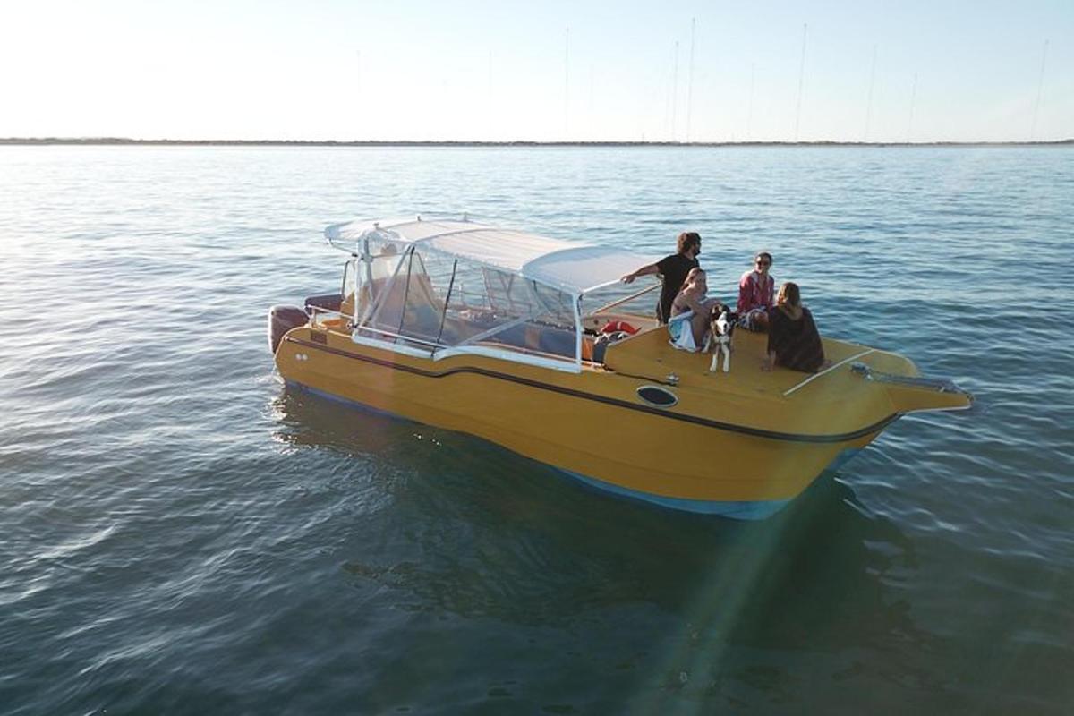 a group of people on a yellow boat in the water