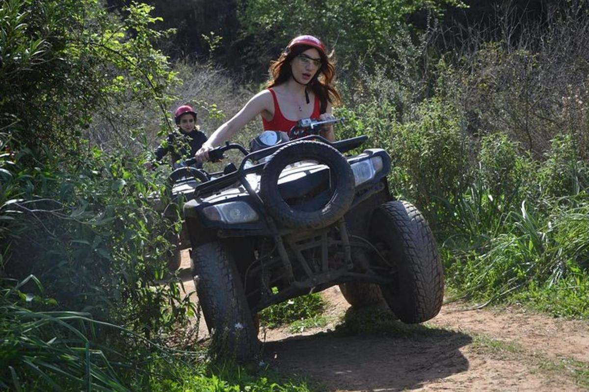 a woman riding a wheeler on a trail