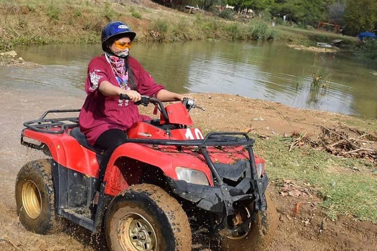 a person on a atv in front of a river