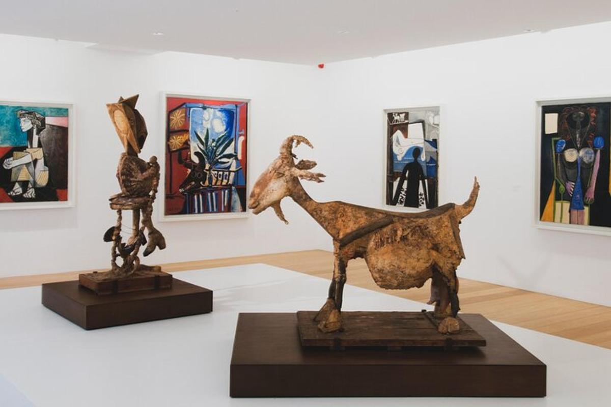 a museum exhibit with a sculpture of a camel and paintings