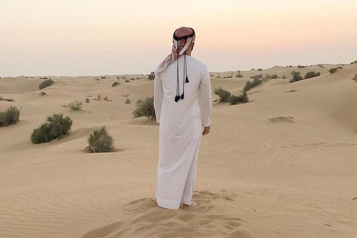 a man standing in the sand in the desert